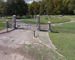 The burial place is divided into three sections by a paved road The burial place is divided into three sections by a paved road.